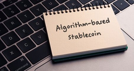 Poster - There is note book with the word Algorithm-based stablecoin on a laptop. It is an eye-catching image.