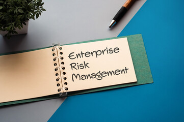 Poster - There is a notebook with the word Enterprise Risk Management. It is eye-catching image.