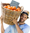 Smiling young man carrying orange fruits in wicker basket
