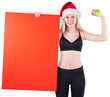 Festive fit blonde smiling at camera holding poster