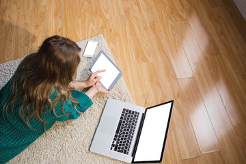 Poster - Woman lying on floor while using her tablet