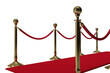 Close up of golden queue barrier with red carpet