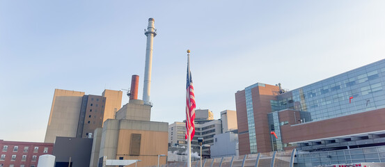 Wall Mural - The US flag on a pole is a symbol of patriotism and unity, representing the country's values, history, and people. Its design and colors have symbolic meaning