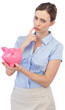 Thoughtful businesswoman with piggy bank