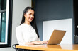 © NVB Stocker - Happy excited successful Beautiful Asian businesswoman triumphing in modern office with laptop, success happy pose. Work from home and social distancing concept