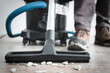 Cleaning construction debris after repair with a powerful construction vacuum cleaner.