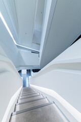 Poster - empty futuristic stairway in modern building. Architectural abstract background