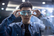 © Blue Jean Images - Young Chinese man wearing futuristic glasses