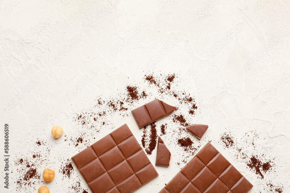 Composition with tasty chocolate, hazelnuts and coffee powder on light background