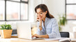 © JenkoAtaman - beautiful young smiling woman working remotely behind laptop at home