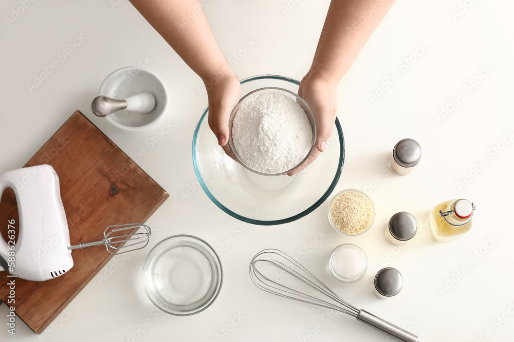 Woman preparing dough for Italian Grissini on white background