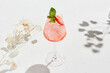 canvas print picture - Strawberry alcoholic cocktail on white background with shadows. Summer drink strawberry spritz with empty place. Strawberry mocktail in minimal style. Pink cocktail in summer menu on light background.