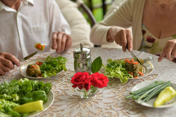 Poster - Elderly couple eating at table at country house 