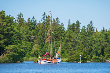 Poster - Lake in a woodland with a beautiful old sailboat