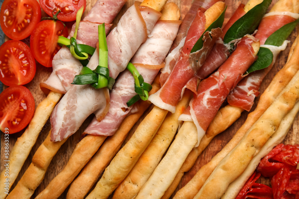 Tasty Italian Grissini with bacon, closeup