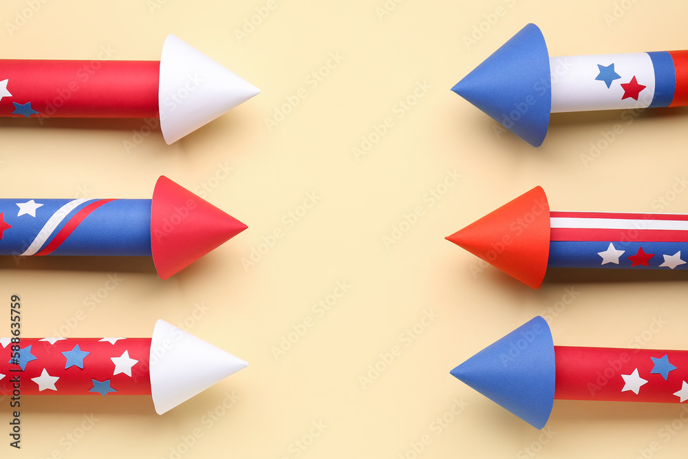 Frame made of firework rockets for Independence Day on beige background