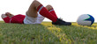 Rugby player lying on the field.
