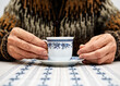 Female pensioner drinking a cup of coffee, United Kingdom