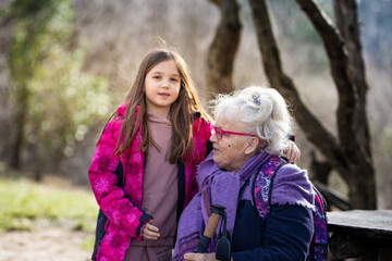 Little girl and her grandma enjoying the nature in the park