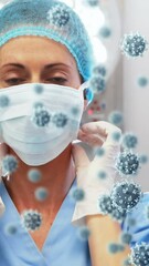 Wall Mural - Animation of caucasian female doctor with face mask over virus cells