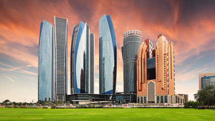Wall Mural - Skyscrapers in Abu Dhabi at dramatic sunset; United Arab Emirates