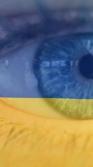Poster - Animation of flag of ukraine waving over open eye of caucasisan woman