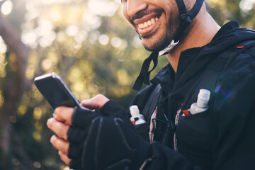 Canvas Print - Sports, man and phone outdoor for cycling, mountain biking or workout and smile in nature. Male person in forest with smartphone in hands for communication, gps travel app or fitness with safety gear