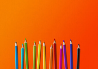 Wall Mural - Colored pencil group isolated on orange. Horizontal background