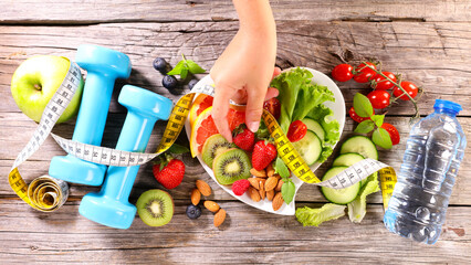 Wall Mural - healthy eating- mixed salad, dumbbell and meter tape- fitness sport, active, slim concept