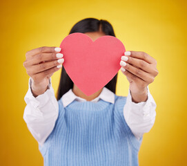 Sticker - Cover, paper and heart with woman in studio for love, support and romance. Valentines day, kindness and date with female hiding with symbol on yellow background for health, happiness and hope mockup