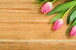 Pink tulips on an old wooden table