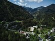 Beautiful view from a drone of a village with curly road surrounded by mountains in Slovenia
