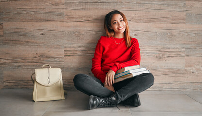 Poster - University, portrait of woman with books and smile on floor, education at college on wall background mockup. Information, knowledge and space, student with backpack and happiness with book to study.