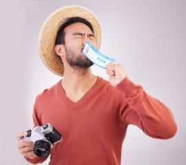 Wall Mural - Excited man, ticket and visa with camera, travel and paperwork for holiday adventure and on white background. Smile, travel and happy person kissing boarding pass for vacation, journey and happiness.