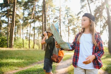 Wall Mural - kids in green forest playing,concept of kids vacations and travel