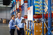 © NVB Stocker - Caucasian team man and woman worker working at warehouse factory. Warehouse staff worker standing by goods shelf working in large warehouse
