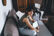 © BullRun - Young female sitting front open laptop computer with blank mock up screen for paste advertising content or web design. Woman freelancer working distantly on netbook. Student learning via online course