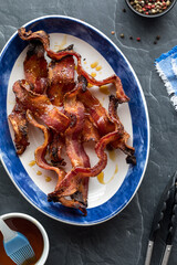 Wall Mural - a platter of crispy peppercorn maple bacon, ready for eating.