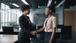© Syntetic Dreams - Two Businesswomen Shaking Hands In Modern Office, female colleagues partners