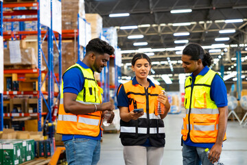 Drink water and looking at mobile phone. Warehouse worker team asian man and woman chat on mobile phone during the break relax time at warehouse factory.