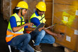 © NVB Stocker - Warehouse staff working on barcode scanner handheld at warehouse factory. Two men warehouse indian worker wearing safety hardhats helmet working in warehouse of Wholesale Merchandise