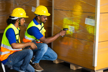 Wall Mural - Warehouse staff working on barcode scanner handheld at warehouse factory. Two men warehouse indian worker wearing safety hardhats helmet working in warehouse of Wholesale Merchandise