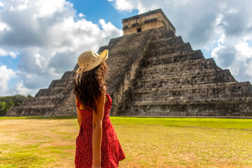 Beautiful tourist observing the old pyramid and temple of the castle of the Mayan architecture known as Chichen Itza these are the ruins of this ancient pre-columbian civilization and part of humanity