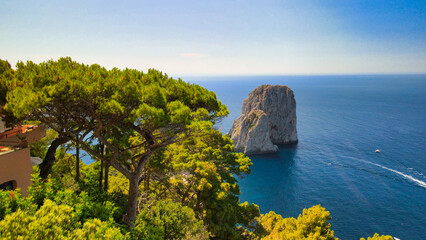 Wall Mural - Amazing aerial view of Faraglioni in summer season. Rock natural formations in Capri Island, Italy