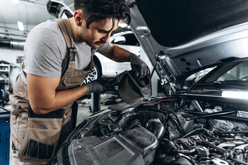 Mechanic examining car in auto car repair service center