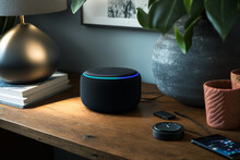 Echo From Amazon Alexa On The Table. Alexa Is A Virtual Personal Assistant Developed By Amazon With The Aim Of Assisting In The Execution Of Some Everyday Tasks. The User Interacts Through Speech.