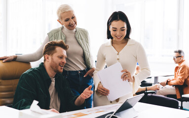 Group of diverse colleagues working on project in office