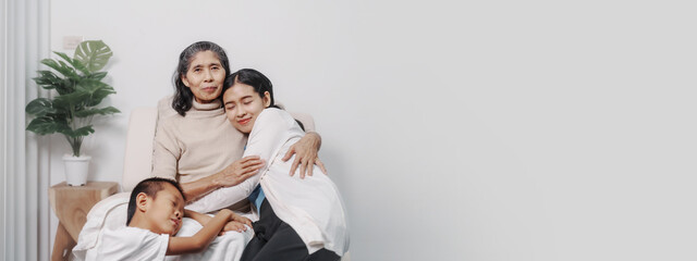 My grandmother and daughter and grandson hugged lovingly while sitting on the sofa with care and warmth, love, valentine, family, care.