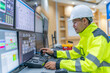 © reewungjunerr - Engineer working at control room,Manager control system,Technician man monitoring program from a lot of monitor
