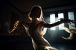 © xartproduction - young woman dancing in the dark in a beautiful white dress by candlelight